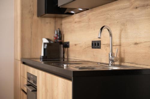 a kitchen with a sink and a counter top at Moderne Wohnung mit einer wunderschönen Aussicht in der Residenz Silvretta, inkl Silvretta Card Premium in See
