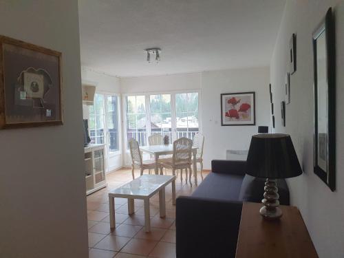a living room with a couch and a table at Moléson Altitude in Moleson
