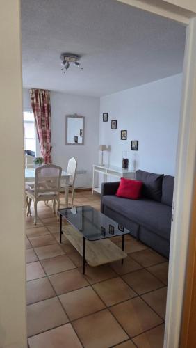 a living room with a couch and a table at Moléson Altitude in Moleson