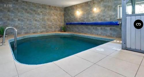 a swimming pool in a room with a inflatable at Willa Bosmański Zakątek in Tałty