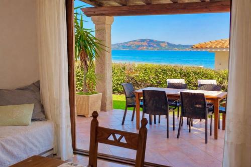 a dining room with a table and a view of the ocean at Villa Rosa in Cannigione