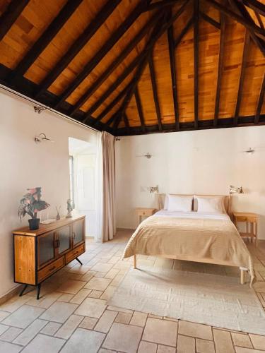 a bedroom with a bed and a wooden ceiling at Faro Town House in Faro