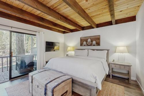 a bedroom with a large bed and a large window at The Cozy King in Kings Beach