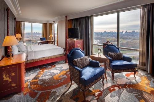 a hotel room with a bed and a desk and chairs at Hilton Lac-Leamy in Gatineau