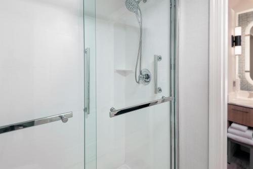 a shower with a glass door in a bathroom at Homewood Suites by Hilton Orlando-Nearest to Universal Studios in Orlando