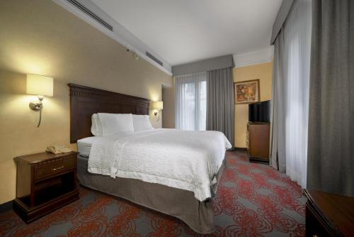 a hotel room with a large bed and a window at Hampton Inn & Suites Mexico City - Centro Historico in Mexico City