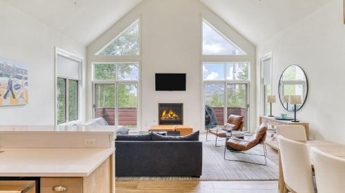 a living room with a couch and a fireplace at Emerald Elk at Village Creek by AvantStay Close to Slopes Village w Views in Telluride