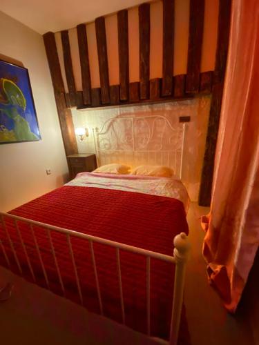 a bedroom with a bed with a wooden headboard at Vojko Holidays - Rustika in Koper