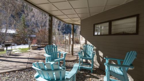 three blue rocking chairs sitting on a porch at Viking Lodge 103 by AvantStay Stunning Condo Near Ski Lift in Telluride
