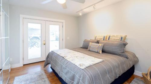 a bedroom with a bed in a room with a door at Viking Lodge 103 by AvantStay Stunning Condo Near Ski Lift in Telluride