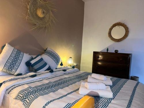 a bedroom with a bed with towels on it at Riad Medina Charme et Sérénité in Essaouira