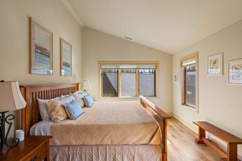 a bedroom with a bed with blue pillows at Big Mountain View Condo in Sisters