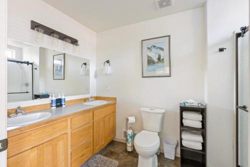 a bathroom with a toilet and a sink at Timber Creek Escape in Sisters