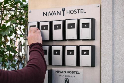 a person is pointing at a nynwegian hospital sign at NIVAN Hostel in Hamburg