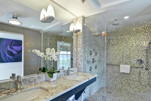 a bathroom with two sinks and a shower at Hilton Garden Inn Raleigh/Crabtree Valley in Raleigh