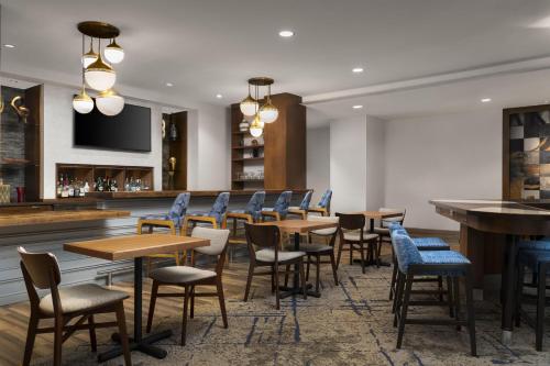 a restaurant with tables and chairs and a bar at Homewood Suites by Hilton Boston Brookline-Longwood Medical in Brookline