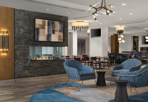 a lobby with chairs and a fireplace at Homewood Suites by Hilton Boston Brookline-Longwood Medical in Brookline