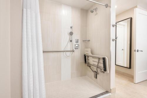 a bathroom with a shower with a shower curtain at Hilton Grand Vacations Club Las Palmeras Orlando in Orlando