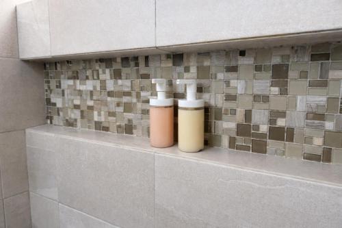 two bottles ofodorizers sitting on a shelf in a bathroom at Casa Nobleza in Manuel F. Martínez