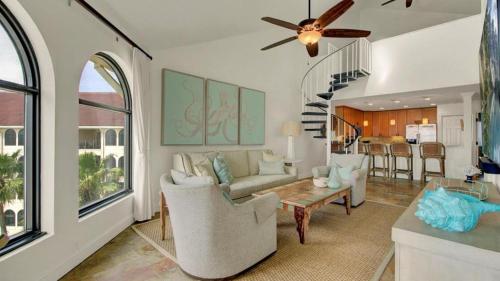 a living room with a couch and a table at 513 Seascape by AvantStay Oceanfront Home w Amazing Views Community Pool Access in Isle of Palms