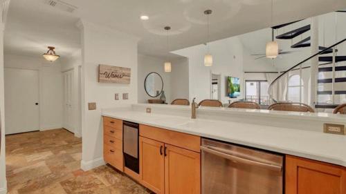 a large kitchen with a counter and a sink at 513 Seascape by AvantStay Oceanfront Home w Amazing Views Community Pool Access in Isle of Palms