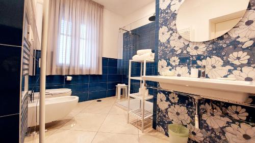 a bathroom with a sink and a toilet and a mirror at Olimpo degli Dei in Agerola