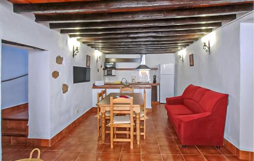 a living room with a red couch and a table at El Pajar in Málaga
