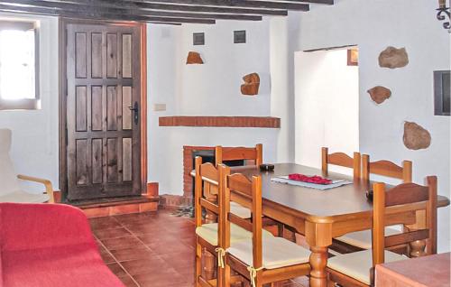 a dining room with a table and chairs and a door at El Pajar in Málaga