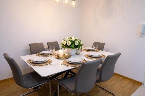 ein Esszimmer mit einem Tisch, Stühlen und Blumen in der Unterkunft Apartment Ivana Imotski near Makarska in Imotski