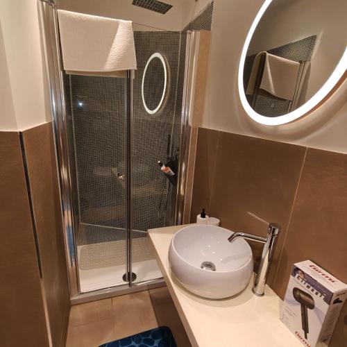 a bathroom with a shower and a toilet and a sink at The Garden Suites in Viterbo