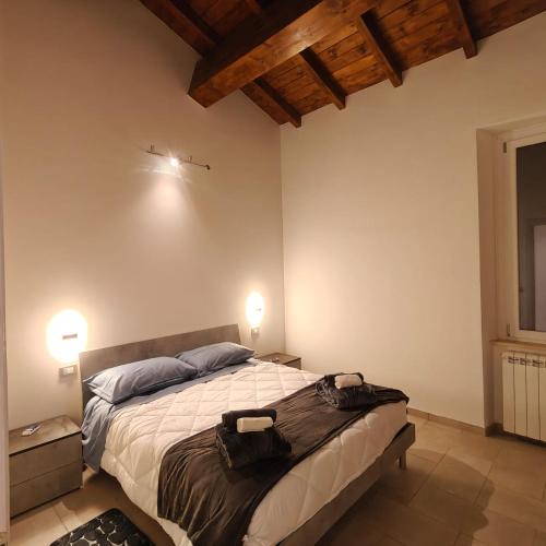 a bedroom with a bed with two bags on it at The Garden Suites in Viterbo