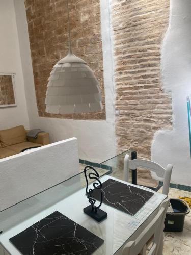 a kitchen with a glass counter top with a table at Moreria Suites in Constantina