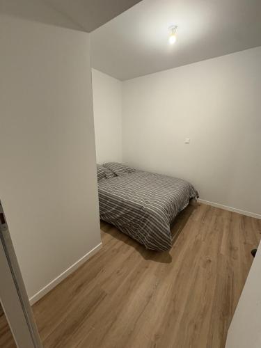 a bedroom with a bed and a wooden floor at LONI EXPERIENCES - L'Escale in Challans