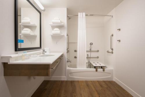 a white bathroom with a sink and a shower at Hampton Inn And Suites By Hilton Portland-Pearl District in Portland