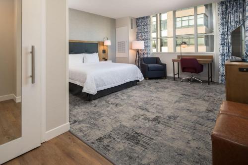 a hotel room with a bed and a desk at Hampton Inn And Suites By Hilton Portland-Pearl District in Portland