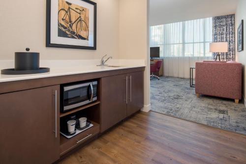 a hotel room with a tv and a living room at Hampton Inn And Suites By Hilton Portland-Pearl District in Portland