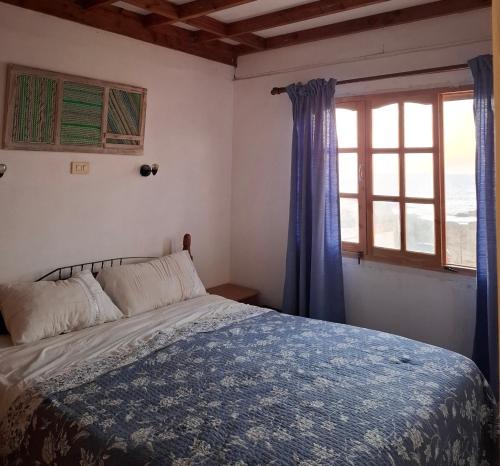 a bedroom with a bed and a window at Casa de playa con espectacular vista in Islote Ramadas