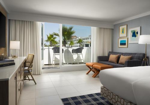 a hotel room with a bed and a living room at Hotel del Coronado, Curio Collection by Hilton in San Diego