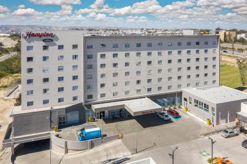 an overhead view of a large white building with a parking lot at Hampton Inn By Hilton Tijuana in Tijuana