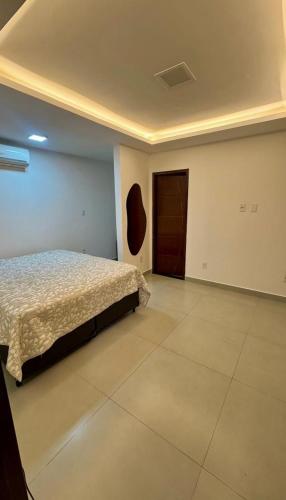 a bedroom with a bed and a door at Casa Condeixa in Cabo Frio