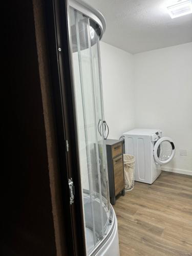 a glass shower in a room with a wooden floor at Vila Bella in Lugugnana