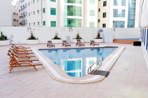 a swimming pool on top of a building at Al HAYAT PALACE HOTEL in Sharjah