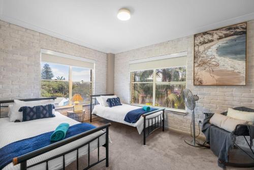 a bedroom with two beds and a window at Ocean Shores 1 in South West Rocks