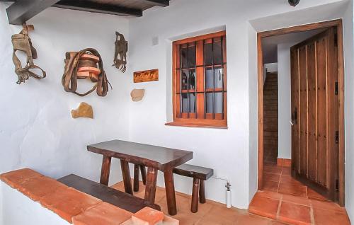 a room with a wooden table and a door at La Cuadra in Málaga