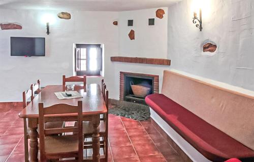 a dining room with a table and a couch and a fireplace at La Cuadra in Málaga