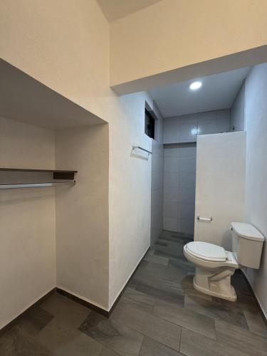 a bathroom with a toilet in a room at Hotel Nuevo Vallarta in Guadalajara