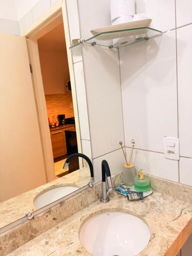 a bathroom counter with a sink and a mirror at RESIDENCIAL SOPHIA in Eunápolis