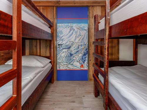 two bunk beds in a room with a mountain mural at Golden Hirsch in Rauris