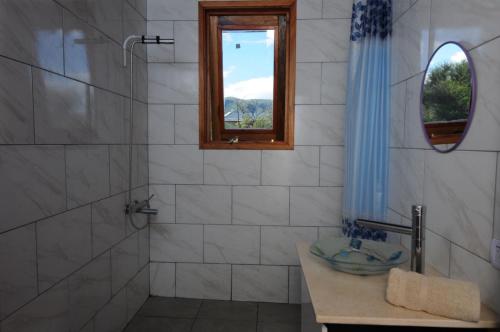 a bathroom with a sink and a window at Estación Tachyón Timalu , ETe-Nea in San Esteban