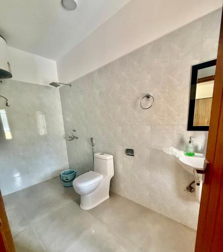 a bathroom with a toilet and a sink at Sompal Service Apartment in Paro